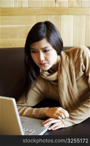 Close-up of a young woman looking at a laptop