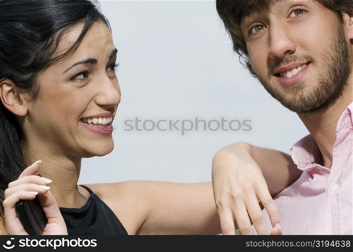 Close-up of a young woman looking at a young man and smiling