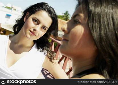 Close-up of a young woman looking at her friend