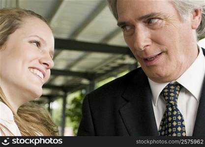 Close-up of a young woman looking at her teacher and smiling