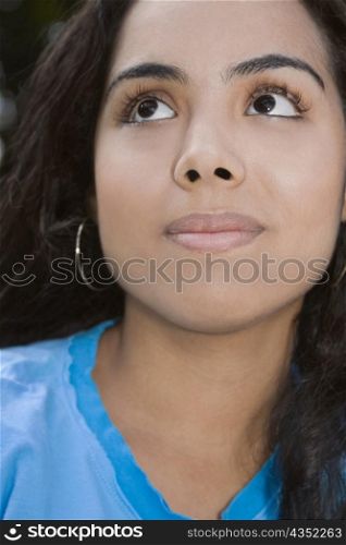 Close-up of a young woman looking up