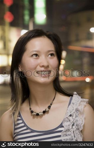 Close-up of a young woman looking up and smiling