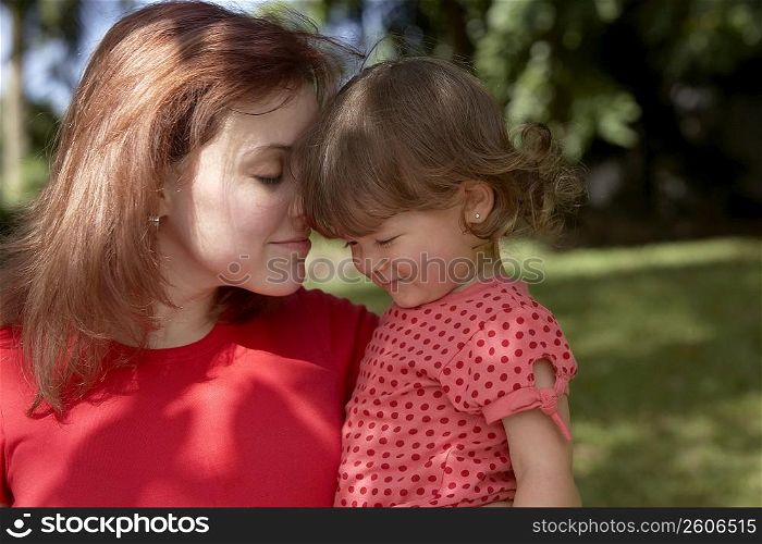 Close-up of a young woman loving her daughter