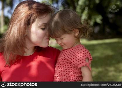 Close-up of a young woman loving her daughter