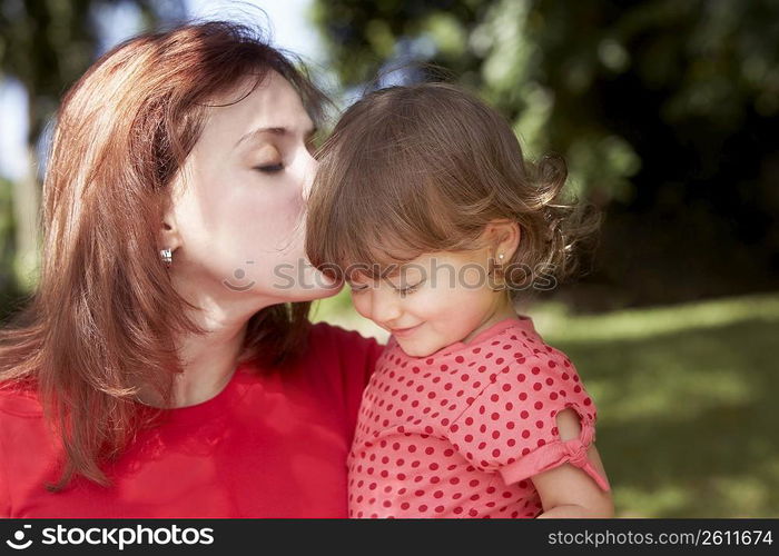 Close-up of a young woman loving her daughter