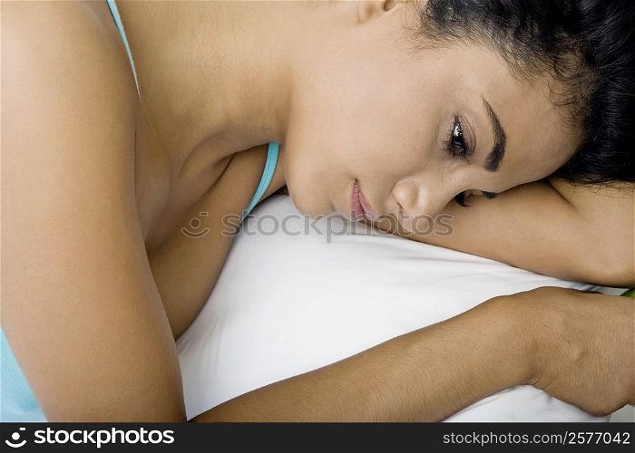 Close-up of a young woman lying on a bed