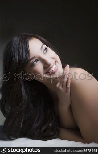 Close-up of a young woman lying on a massage table and smiling