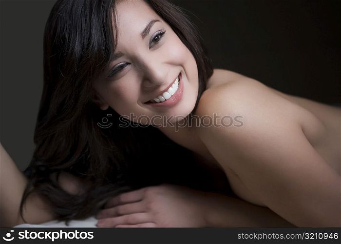 Close-up of a young woman lying on a massage table and smiling