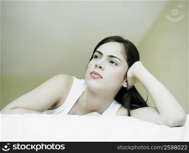 Close-up of a young woman lying on the bed