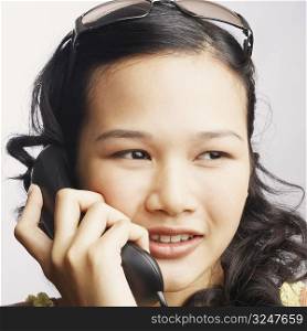 Close-up of a young woman on the phone and looking sideways