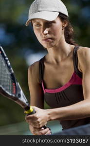 Close-up of a young woman playing with a tennis racket