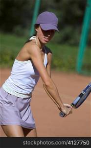 Close-up of a young woman playing with a tennis racket
