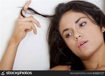 Close-up of a young woman playing with her hair