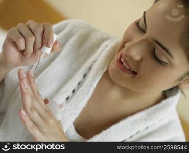 Close-up of a young woman polishing her nails