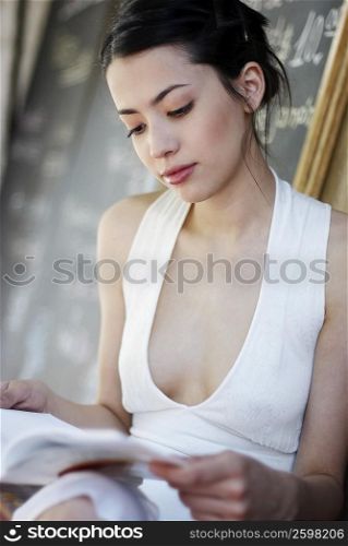Close-up of a young woman reading a book