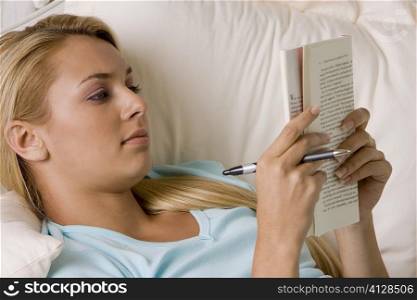 Close-up of a young woman reading a book