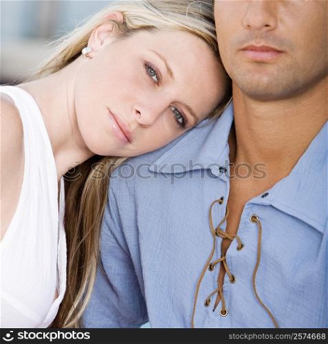 Close-up of a young woman resting her head on a mid adult man&acute;s shoulder