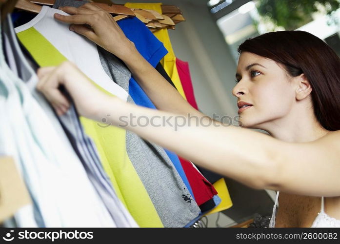 Close-up of a young woman selecting clothes in a clothing store