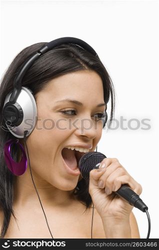 Close-up of a young woman singing into a microphone