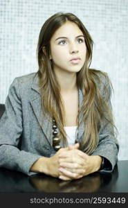 Close-up of a young woman sitting at a table