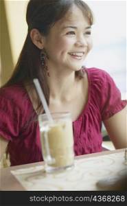 Close-up of a young woman sitting in a restaurant