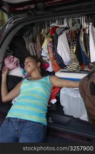 Close-up of a young woman sleeping in a car