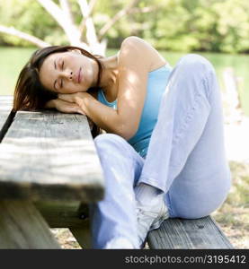 Close-up of a young woman sleeping on a bench