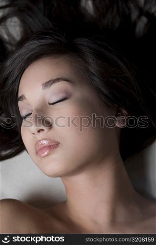 Close-up of a young woman sleeping on a massage table