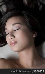 Close-up of a young woman sleeping on a massage table