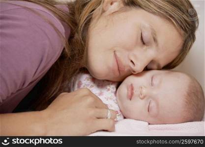 Close-up of a young woman sleeping with her daughter