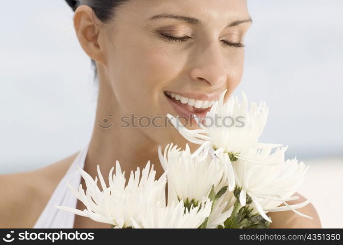 Close-up of a young woman smelling flowers