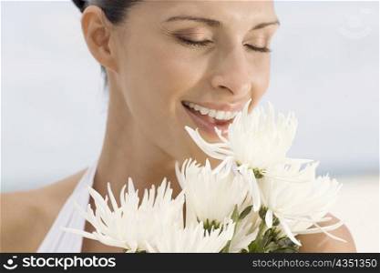 Close-up of a young woman smelling flowers