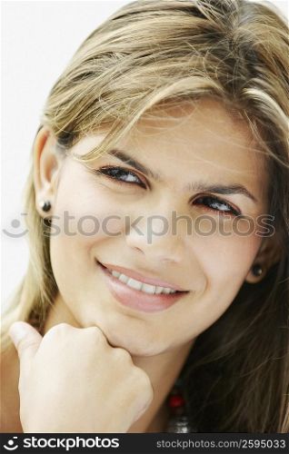 Close-up of a young woman smiling and looking away
