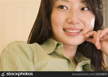 Close-up of a young woman smiling and looking sideways