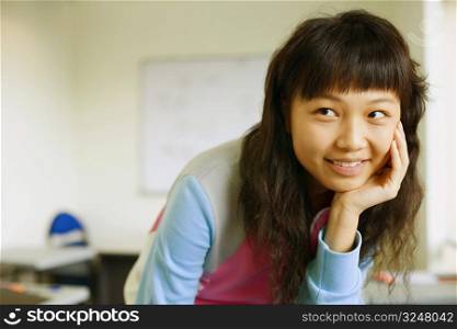 Close-up of a young woman smiling in the classroom