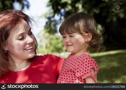 Close-up of a young woman smiling with her daughter