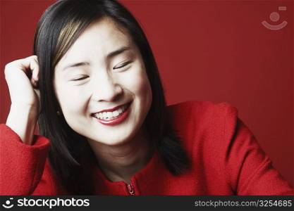 Close-up of a young woman smiling with her eyes closed