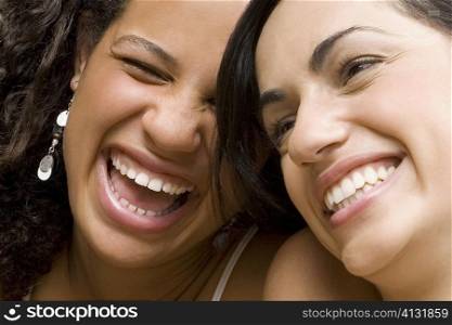 Close-up of a young woman smiling with her friend