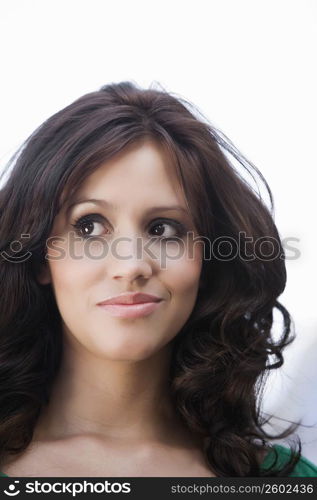 Close-up of a young woman smirking and looking away