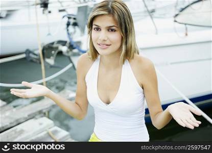 Close-up of a young woman standing at a dock and gesturing