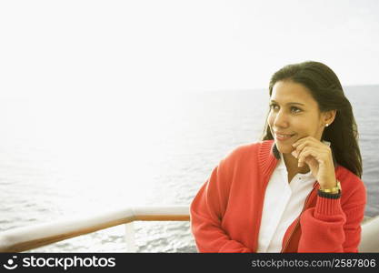 Close-up of a young woman standing on a boat deck