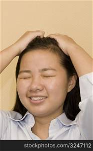 Close-up of a young woman suffering from a headache
