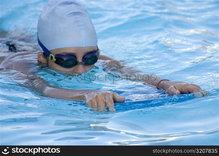 Close-up of a young woman swimming in a swimming pool