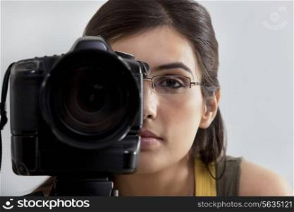 Close-up of a young woman taking a photograph