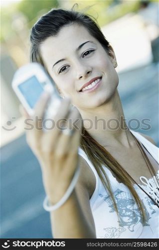 Close-up of a young woman taking a photograph of herself