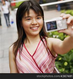 Close-up of a young woman taking a picture of herself