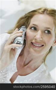 Close-up of a young woman talking on a cordless phone