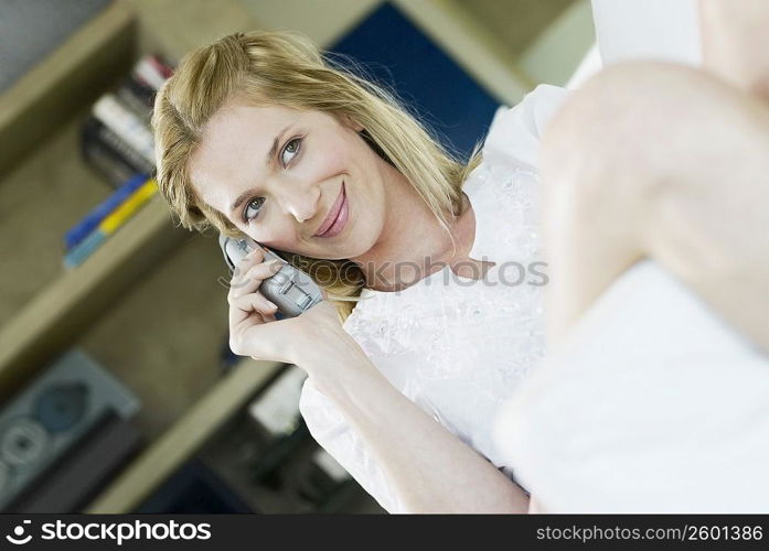 Close-up of a young woman talking on a cordless phone