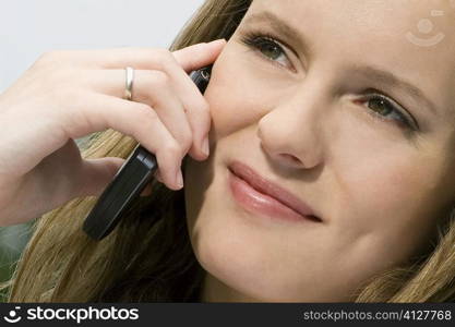 Close-up of a young woman talking on a mobile phone