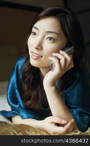 Close-up of a young woman talking on a mobile phone